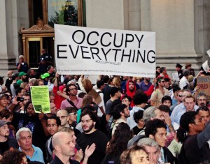 Day 14 (Sep. 30, 2011) of Occupy Wall Street -- protester holds up sign "Occupy Everything". Day 14 (9/30/2011) of OWS